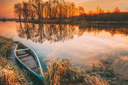 Lake River And Old Wooden Blue Rowing Fishing Boat At Beautiful Sunrise In Autumn Morning. Autumn Peaceful Landscape.