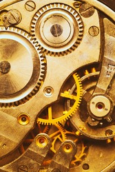 Close-Up Of Old Clock Watch Mechanism. Retro Clockwork Watch With Golden Gearwheels Gears. Vintage Movement Mechanics. Golden Colour.