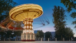 Set. Brightly Illuminated Rotating High Speed Carousel Merry-Go-Round. Summer Evening Night In City Amusement Park. Attraction Ferris Wheel On Summer Evening In City Amusement Park..