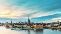 Stockholm, Sweden. Scenic View Of Stockholm Skyline At Summer Evening. Famous Popular Destination Scenic Place In Dusk Lights. Riddarholm Church In Day To Night Transition Time Lapse.