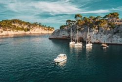 Cote de Azur, France. White Yachts boats in bay. Calanques - a deep bay surrounded by high cliffs in the azure coast of France.