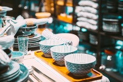 View of assortment of decor for interior shop in store of shopping center. Home accessories and household products for dining room in store of shopping centre. View of beautiful dinnerware on table