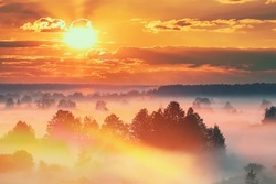 Amazing Sunrise Sunset Over Misty foggy Landscape Scenic View Of Morning Sky With Rising Sun Above Forest. altered sunrise sky.