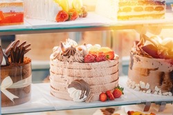 cake with strawberries, yummy assortment baked pastry in bakery. Various Different Types Of Sweet Cakes In Pastry Shop Glass Display. Good Assortment Of Confectionery. buffet with many desserts.