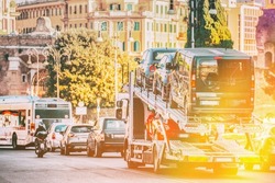 Auto-transport Carrying New Cars In European City Street. Auto Transport Broker Or Car Transporter. Auto-transport Carrying New Fiat Cars In City Street. Auto Transport Broker Or Car Transporter