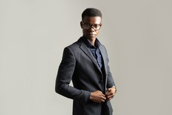 portrait of young african man in suit with glasses 