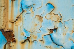Texture of blue and yellow metal wall with rust and peeling paint, can be used as overlay or texture