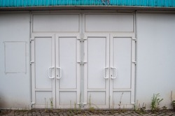 Old metal closed doors of the sports complex