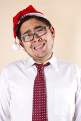 sad Santa, businessman wear red tie and santa hat act crying.