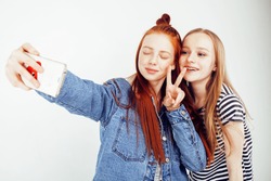 lifestyle people concept: two pretty stylish modern hipster teen girl having fun together, happy smiling making selfie 