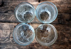 Top view of four glasses of water with ice