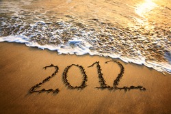 The welcome of the new year 2012 dramatic message in the sand at the beach near the ocean