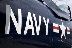 US Navy markings on the side of a restored vintage aircraft.