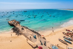 Pier and boats on turquoise water in city of Santa Maria, Sal, Cape Verde
