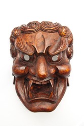 Japanese demon mask carving from wood isolated on white background