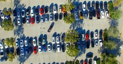 Parking lots full of vehicles. Birds eye view.