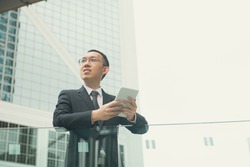 asian businessman with tablet computer on  hong kong central district
