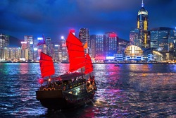 hong kong night view with junk ship on foreground