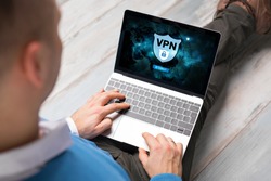 Man using VPN (Virtual Private Network) for secure and encrypted connection, also using internet anonymously.