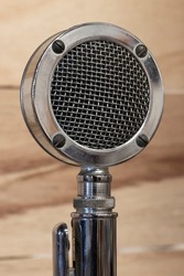 Antique Radio Microphone in chrome with wood background. 