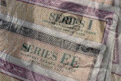 US Savings Bonds with 100 dollar bill overlay. Savings bonds are debt securities issued by the U.S. Department of the Treasury. They are issued in Series EE or Series I.