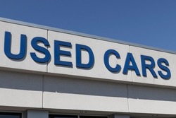 Used Car sign at a pre-owned car dealership. As supplies of new cars dwindle, used cars become more popular.