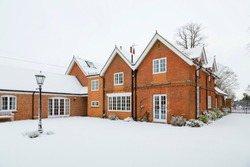 Snow covered English country house in winter, UK