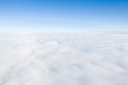 Aerial view flying above clouds in the atmosphere, depicts heaven, Earth and the environment