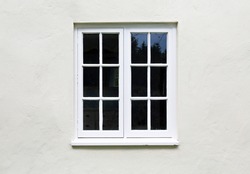 Wooden windows and sill on a home exterior. Cottage windows, UK
