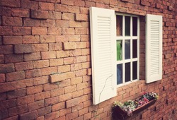 Window on a red brick wall with vintage tone