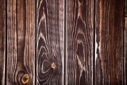Dark wood boards texture close up. Vintage wooden surface background. Unpainted natural hardwood boards texture. Weathered surface of the old planks of wooden wall close-up. High contrast wood. 