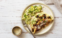 Omelet with mushrooms and cucumber salad on shabbywoodenbackground. Flat lay. Copy space. Low carb diet concept