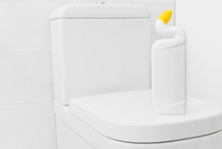 Toilet cleaner bottle mockup for design on white lavatory pan