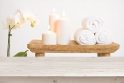 Wooden table in front of blurred background of spa products