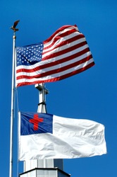 Church stands between the Christian flag and the American Flag.