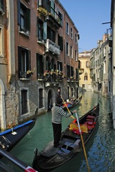 Gondola passes by on a waterway on the Grand Canal in Venice,Italy