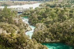 water rapids and dam, forest background, water power, taupo, new zealand. High quality photo