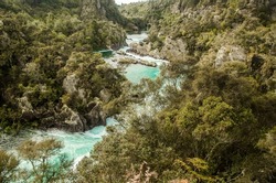 water rapids and dam, forest background, water power, taupo, new zealand. High quality photo