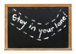 Stay in your lane written in white chalk on a black chalkboard isolated on white