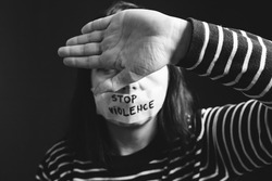 Women violence and abused concept. Stop domestic violence against women and human trafficking.Woman with tape on mouth and stop violence text