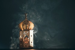 Ramadan Kareem background. Ornamental Arabic lantern glowing at night