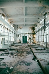 Abandoned ruined industrial building room inside interior, dark dirty grunge and creepy atmosphere