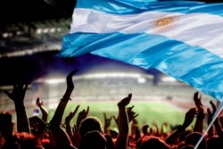 soccer supporters in stadium and Argentina flag