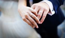 Newly wed couple's hands with wedding rings