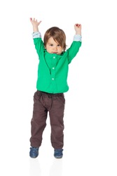 Beautiful little child, 2 years old boy, with hands up in the air, wearing shirt and jeans. High resolution image isolated on white background with copy space. Studio shot.