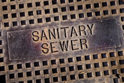 Sanitary sewer man hole cover iron lid with texture and grunge