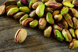 Close-up image of pistachios on wooden background