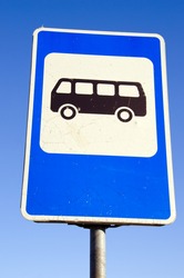 Bus stop road sign on background of blue sky. Information sign.