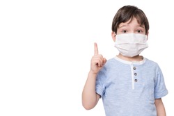 Portrait of kid with face mask pointing finger up, isolated on white background