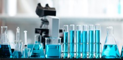 Chemistry laboratory glassware, science laboratory research and development concept, flask, beaker, and test tubes with blue liquid water sample test, scientific test tubes equipment
